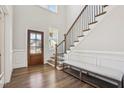 Grand entryway with hardwood floors, bench seating, and a staircase with a wrought iron railing at 272 W Weatherford Dr, Angier, NC 27501