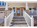 Inviting front porch with brick stairs and a white railing leading to the front door at 272 W Weatherford Dr, Angier, NC 27501