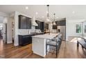 Modern kitchen with dark cabinets, a large center island, pendant lighting, and stainless steel appliances at 272 W Weatherford Dr, Angier, NC 27501