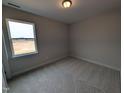 A well-lit bedroom with neutral carpet, large window offering natural light and a closet for storage at 46 Steppe Way, Garner, NC 27529