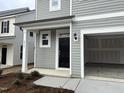 Two-story home featuring a black front door and covered porch at 4937 S Trout Crest, Raleigh, NC 27604