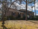 Traditional brick home with black shutters and mature trees on a spacious lot and walkway at 501 Queensferry Rd, Cary, NC 27511