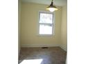 Simple dining area with tile floor and window at 648 Linfield Dr, Durham, NC 27701