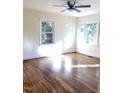 Bright living room with hardwood floors and large windows at 648 Linfield Dr, Durham, NC 27701