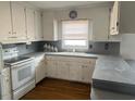 Classic kitchen with white cabinets and gray countertops at 8110 Nc 210 N, Angier, NC 27501