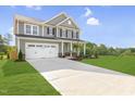 Two-story house with gray siding, white trim, and a two-car garage at 8805 Melvin St # 35, Willow Springs, NC 27592