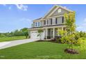 Two-story house with gray siding, white trim, and a two-car garage at 8805 Melvin St # 35, Willow Springs, NC 27592