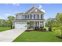 Two-story house with gray siding, white trim, and a two-car garage at 8805 Melvin St # 35, Willow Springs, NC 27592