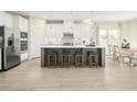Modern kitchen with white cabinets, stainless steel appliances, and an island at 8829 Tartan Clan Dr, Willow Springs, NC 27592
