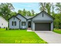 Charming one-story home with gray siding, two-car garage, and manicured lawn at 116 Mohave Dr, Louisburg, NC 27549