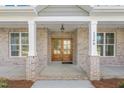 Elegant entryway featuring a stunning wood door and classic brick columns at 1246 Jamestowne Dr, Elon, NC 27244