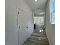 Bright hallway with wood-look floors, leading to an open-concept living space filled with natural light at 136 Parker Ln, Mebane, NC 27302