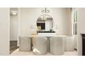 Bright dining room with a round table, four chairs, and a large mirror at 143 Hanover Dr, Sanford, NC 27330