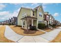 Two-story townhome showcasing a side view and landscaped yard at 1701 Mallard Trace Dr, Wendell, NC 27591