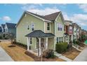 Two-story townhome with a metal roof and charming porch at 1701 Mallard Trace Dr, Wendell, NC 27591