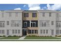 Rendering of brick townhome with stylish exterior, featuring a welcoming entrance and covered balcony at 205 Broomgrove Way, Wake Forest, NC 27587