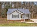 Gray house exterior with dark metal roof and landscaping at 210 Charlotte Ct, Clayton, NC 27520