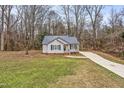 House exterior, showcasing a gray siding and dark metal roof at 210 Charlotte Ct, Clayton, NC 27520
