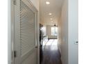 Bright hallway with wood flooring and view into kitchen at 2426 Gathering Square Ct # 2426, Fuquay Varina, NC 27526