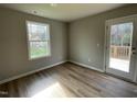 Cozy bedroom with wood-look floors and access to a deck at 309 Starry Sky Dr, Benson, NC 27504