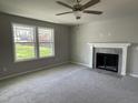 Bright living room featuring a fireplace and large windows at 309 Starry Sky Dr, Benson, NC 27504