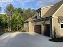 Spacious two-car garage with ample parking on a wide concrete driveway and beautiful yard with mature landscaping at 3913 Cedar Knolls # 7, Youngsville, NC 27596