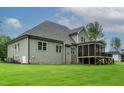 Rear view of a home featuring a screened porch, spacious lawn, and gray siding at 3913 Cedar Knolls # 7, Youngsville, NC 27596