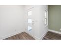 Bright entryway with stylish door with windows, wood-look flooring, and fresh white paint at 3935 Willow Gate Way, Knightdale, NC 27604