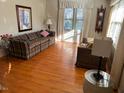 Bright living room with hardwood floors and large windows at 404 W Ninth St, Siler City, NC 27344