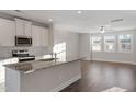 Open kitchen design featuring granite countertops, stainless appliances, and bright natural light at 5302 River Reach Dr, Raleigh, NC 27616