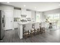 Spacious kitchen with white cabinets, granite island, and stainless steel appliances at 600 Mohinda Way, Willow Springs, NC 27592