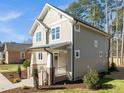 This home has a manicured lawn, traditional architecture, and a welcoming brick-lined front porch at 713 Heidelberg St, Durham, NC 27704