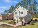 Two-story home with manicured lawn, a traditional design, and a welcoming brick-lined front porch at 713 Heidelberg St, Durham, NC 27704