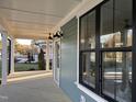 Inviting covered porch with dark exterior windows and ceiling fans at 715 Heidelberg St, Durham, NC 27704