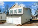 View of the side of the house, showcasing the garage and siding at 810 Brake St, Nashville, NC 27856