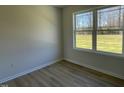 Bright bedroom with large window and wood-look flooring at 83 Harvest Hills Ln, Dunn, NC 28334