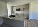 Modern kitchen with granite countertops and stainless steel appliances at 83 Harvest Hills Ln, Dunn, NC 28334