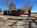 Brick ranch house with covered porch and side entry at 1002 Godwin Ln, Dunn, NC 28334