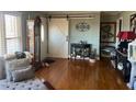 Living room with hardwood floors, fireplace, and barn door at 1002 Godwin Ln, Dunn, NC 28334