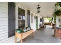 Front porch features a wooden planter box and hanging baskets at 1006 W Broad St, Dunn, NC 28334