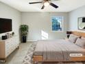 Spacious bedroom with carpeted floors and a ceiling fan at 1100 Somerset Rd, Raleigh, NC 27610