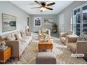 Virtually staged living room with beige couches and rug at 1100 Somerset Rd, Raleigh, NC 27610