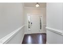 Inviting entryway featuring dark hardwood floors, fresh paint, and classic trim work at 1122 Tulip Poplar Rd, Fuquay Varina, NC 27526