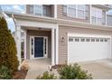 Two-story house entrance with a dark blue door and white trim at 1122 Tulip Poplar Rd, Fuquay Varina, NC 27526