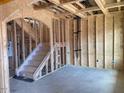 Unfinished Living Room with a staircase leading to the second level at 116 Black Walnut Dr # 203, Garner, NC 27529