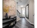 Spacious foyer with hardwood floors, large mirror, and a statement art piece at 1185 Atterlee Ln, Graham, NC 27253
