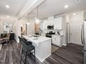 Open concept kitchen with white cabinets, stainless steel appliances and an island at 1185 Atterlee Ln, Graham, NC 27253