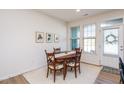 Bright dining room with wooden table and four chairs at 1609 Mallard Trace Dr, Wendell, NC 27591