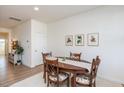 Dining room with oval table, four chairs, and framed botanical prints at 1609 Mallard Trace Dr, Wendell, NC 27591