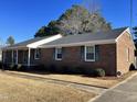 Brick ranch home with covered porch and mature landscaping at 1641 Bridgedale Dr, Rocky Mount, NC 27803